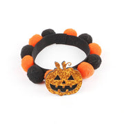 Halloween pet collar with black and orange fur balls and a glittery pumpkin charm for dogs and cats